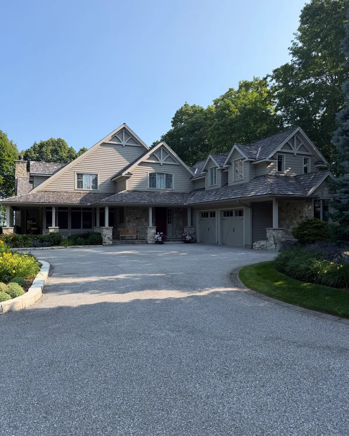 A Craigleith home seen from the driveway after repainting, its gables, dormers and garage doors all refinished.
