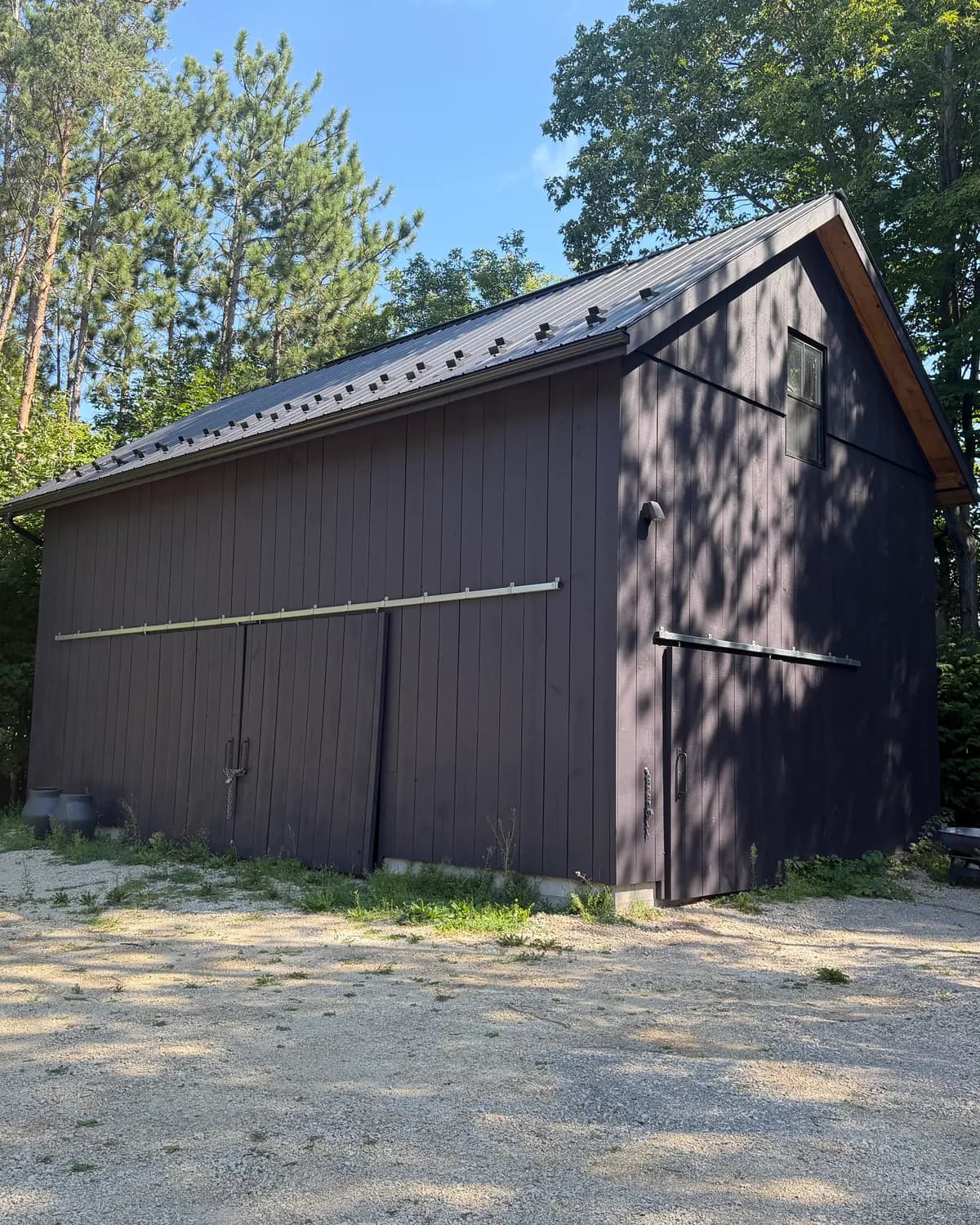 The barn on a Nottawa property, stained in the same deep purple as the house with two coats of solid stain.
