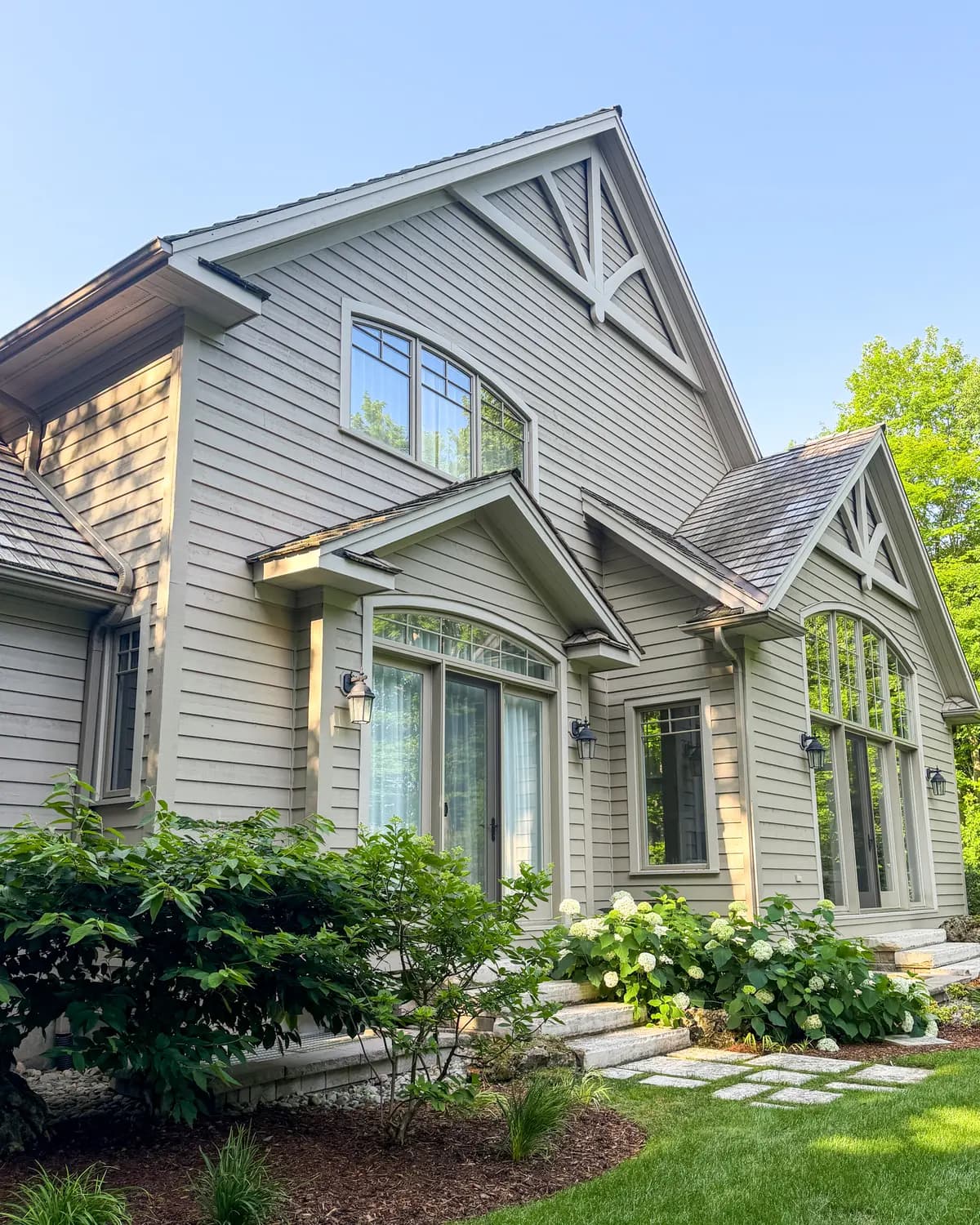 A Craigleith home from the garden, gables, dormers and cedar shake accents all repainted.