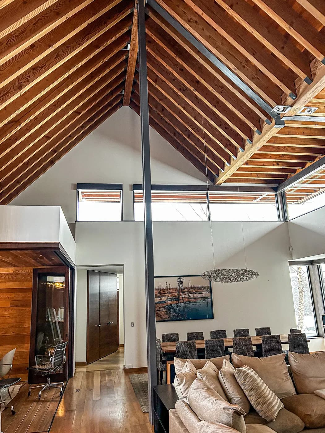 Exposed timber rafters above a Clarksburg living room, the walls and ceiling boards between them painted clean white.